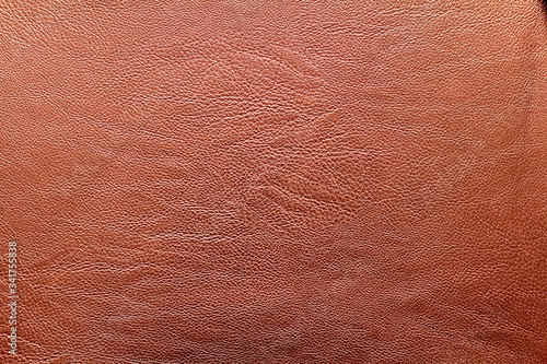 Natural brown leather texture. It can be used for upholstery of furniture, car interior, clothing.