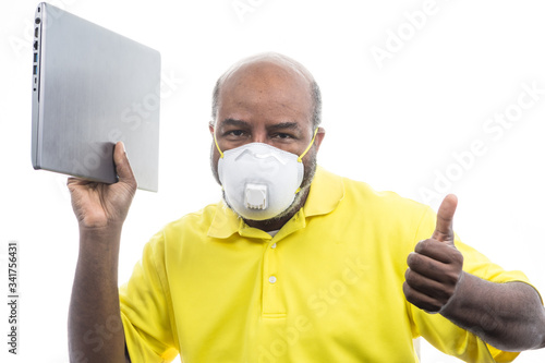 African American Man with medical mask on Laptop Computer. Concept of Lockdown, Flatten the Curve, Social Distancing, State of Emergency, Corona Virus