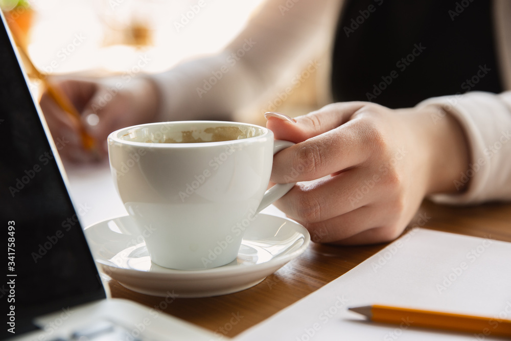 Holding coffee cup. Close up of caucasian female hands, working in office. Concept of business, finance, job, online shopping or sales. Copyspace for advertising. Education, communication freelance. Holding coffee cup. Close up of caucasian female hands, working in office. Concept of business, finance, job, online shopping or sales. Copyspace for advertising. Education, communication freelance.