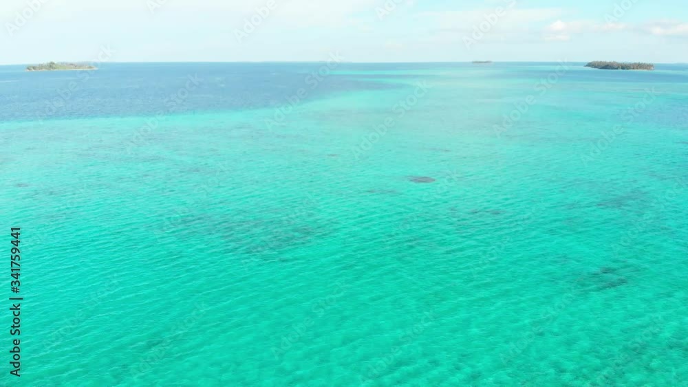 Aerial: flying over exotic tropical island secluded destination away from it all, coral reef caribbean sea turquoise water white sand beach. Indonesia Sumatra Banyak islands. Aerial: flying over exotic tropical island secluded destination away from it all, coral reef caribbean sea turquoise water white sand beach. Indonesia Sumatra Banyak islands.