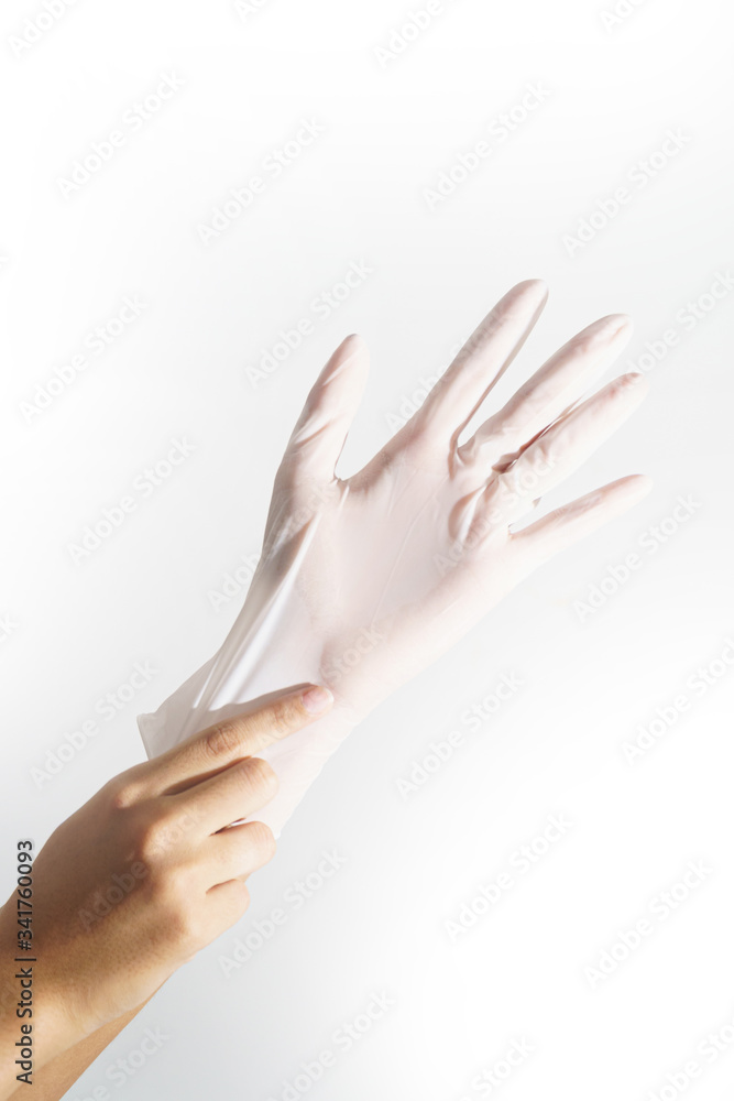 Woman hands wering rubber glove protection safety covid 19 white background