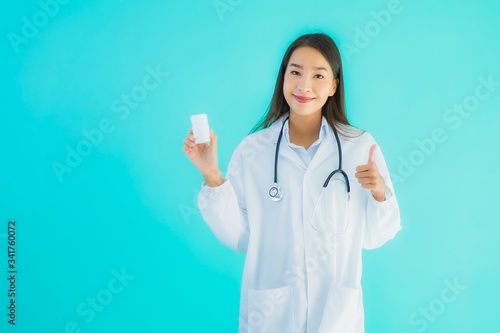 Portrait beautiful young asian doctor woman with drug medicine bottle