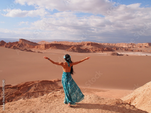 Girl model with long black hair in the long blue dress, Moon Valley, Atacama Desert, San Pedro de Atacama, Chile
