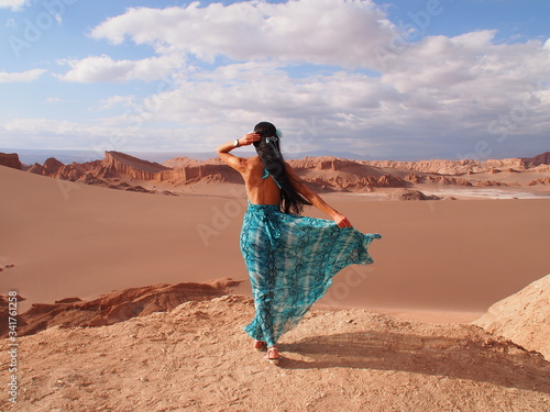 Girl model with long black hair in the long blue dress, Moon Valley, Atacama Desert, San Pedro de Atacama, Chile