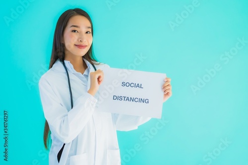 Portrait beautiful young asian doctor woman with sign paper with social distancing