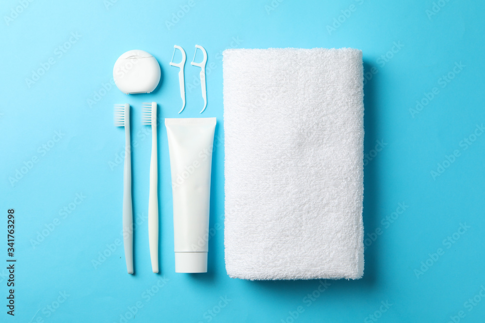 Obraz premium Flat lay with tools for dental care on blue background