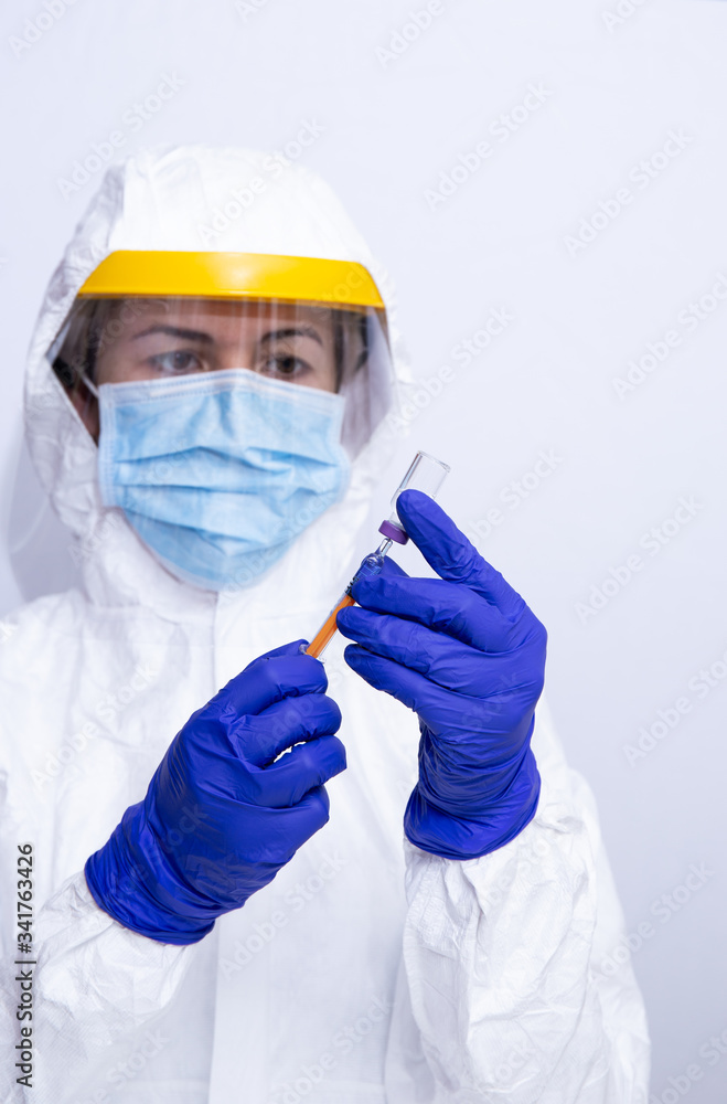 nurse with coronavirus protection equipment loads medication with a syringe selected focus nurse with coronavirus protection equipment loads medication with a syringe selected focus