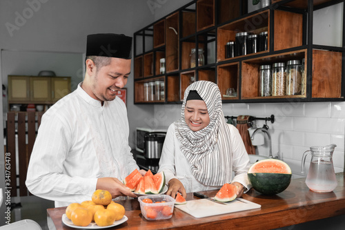 muslim couple preparing for breaking the fast on ramadan month