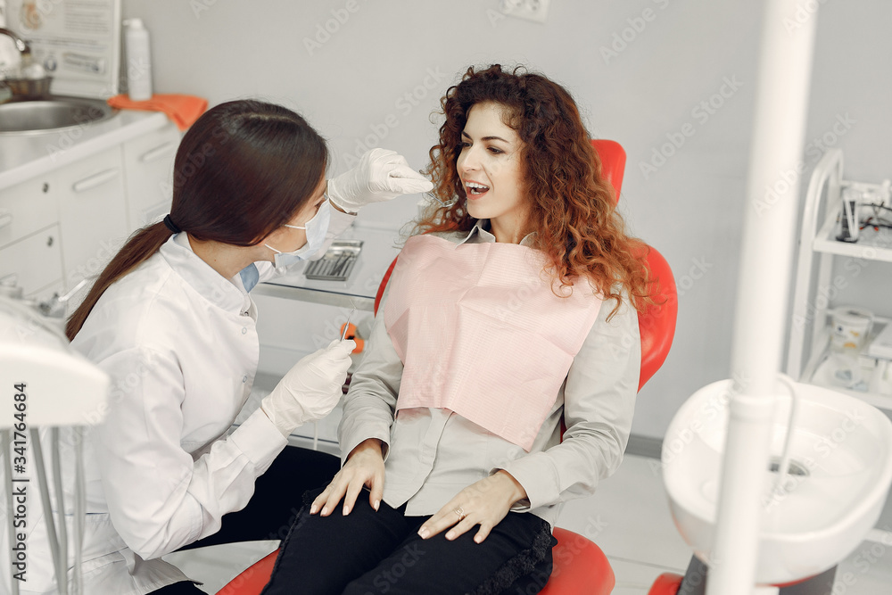 Woman in the dentist's office. Doctor in a uniform. Woman in the dentist's office. Doctor in a uniform.