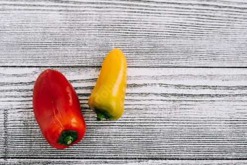Red and yellow pepper on a white wooden background. Fruits and vegetables. Food photography.