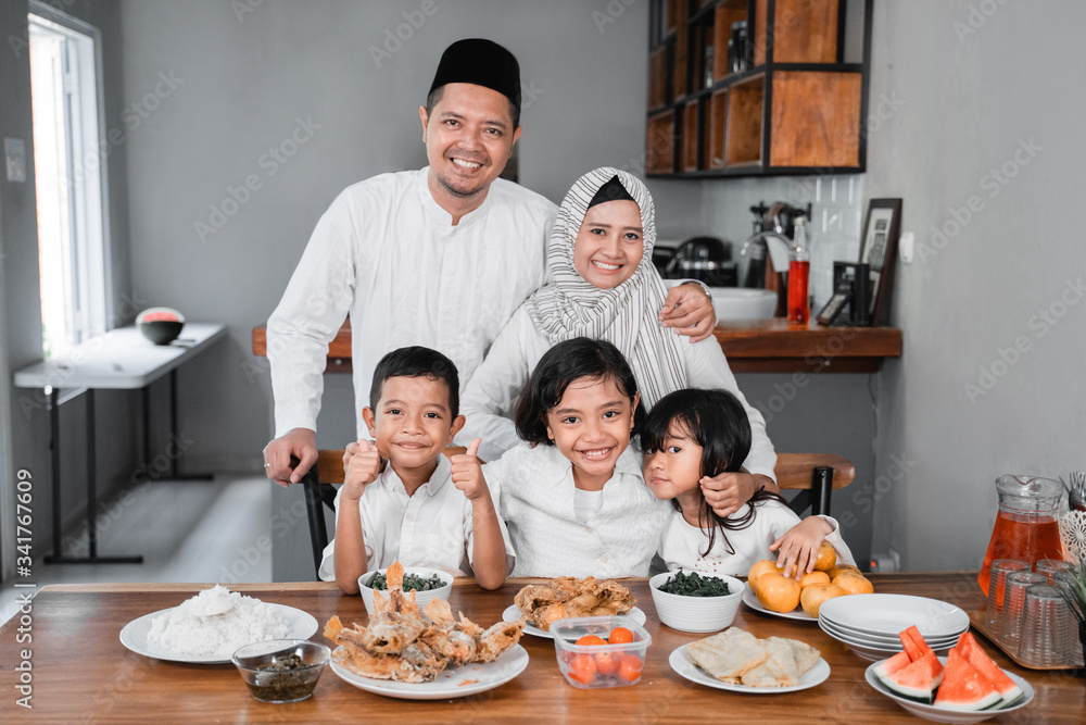 portrait of beautiful asian muslim family breaking the fast together