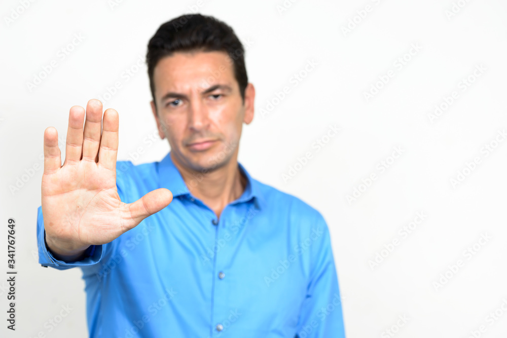 Portrait of stressed mature businessman with stop gesture Portrait of stressed mature businessman with stop gesture