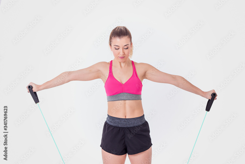 Young woman working out with rubber bands Young woman working out with rubber bands