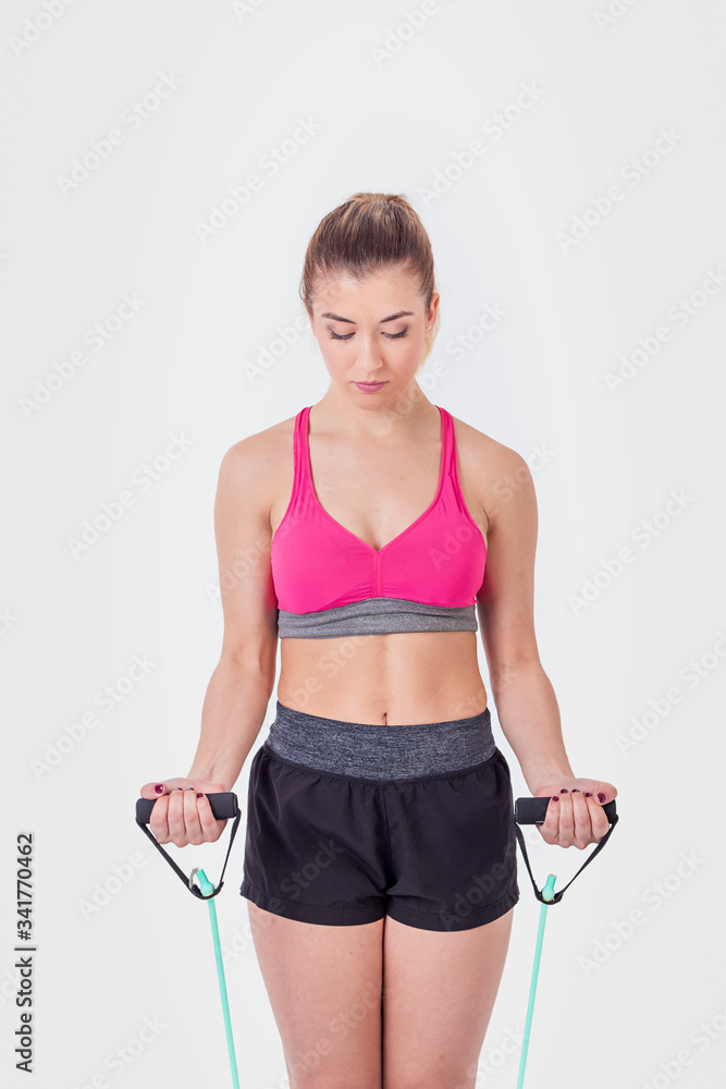 Young woman working out with rubber bands Young woman working out with rubber bands