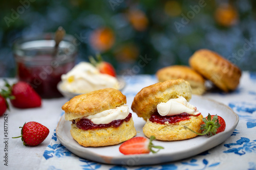 Tableau sur toile Freshly baked home made scones with strawbery jam and clotted cream