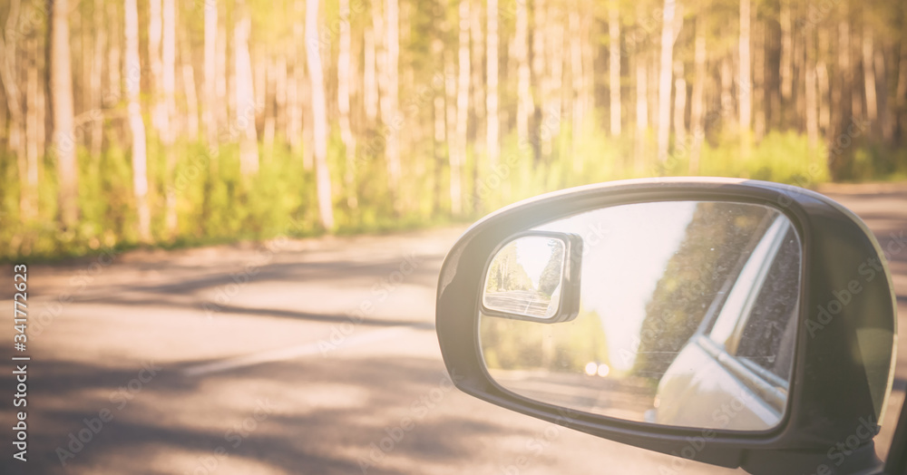 View of side mirror car on country road View of side mirror car on country road