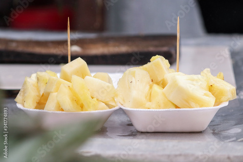 Photograph of a Pine apple cut by a fruit seller near Teesta barrage in Siligur photo