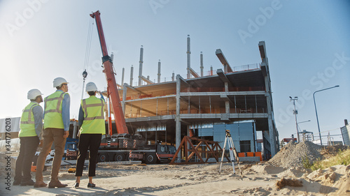 Canvas Print Diverse Team of Specialists Inspect Commercial, Industrial Building Construction Site