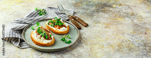Canape or crostini with toasted baguette, cottage cheese, fig jam