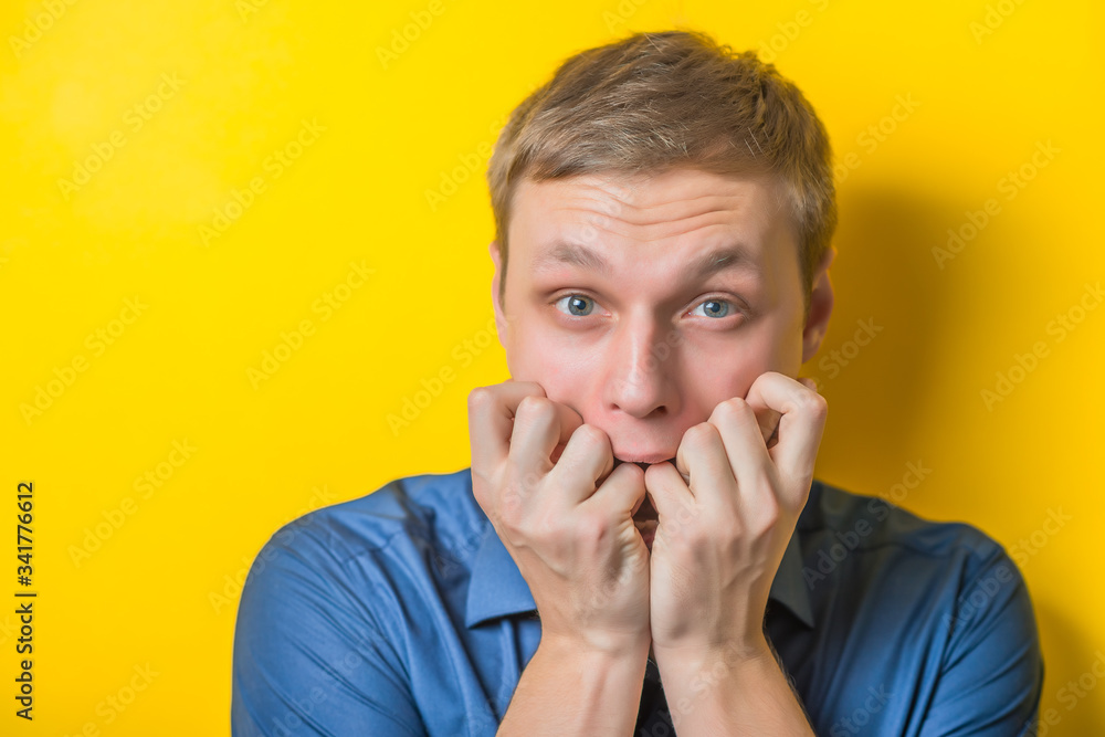 Blond young man. Gesture. does not know what to do, confusion. Isolated yellow background. Blond young man. Gesture. does not know what to do, confusion. Isolated yellow background.