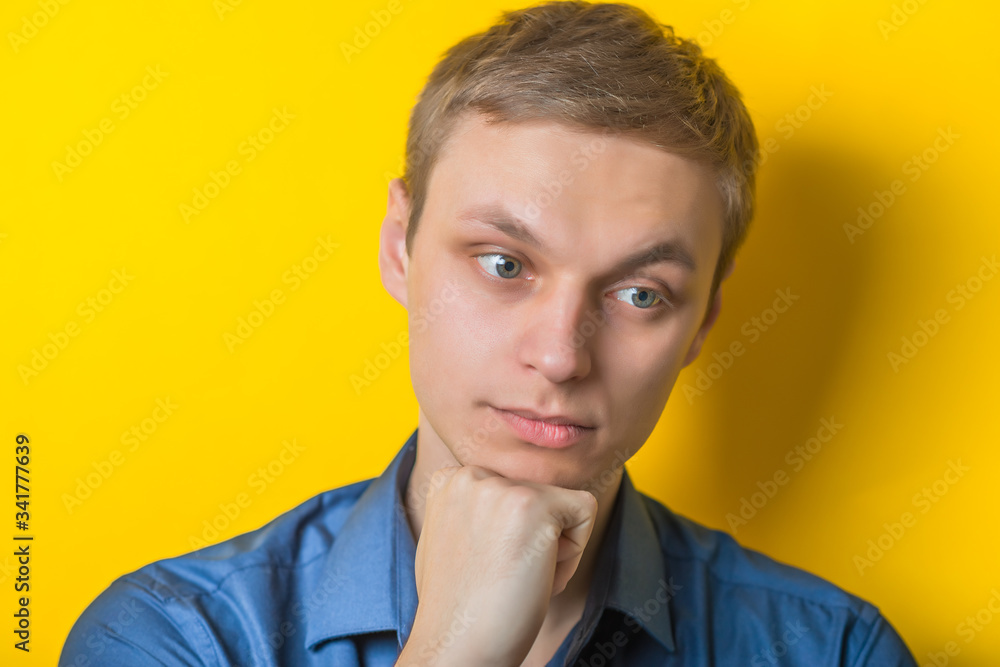 Portrait of handsome young thoughtful man isolated over yellow background Portrait of handsome young thoughtful man isolated over yellow background