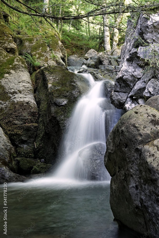 Silky looking waterfall view. Greenish environment and refreshing water Silky looking waterfall view. Greenish environment and refreshing water