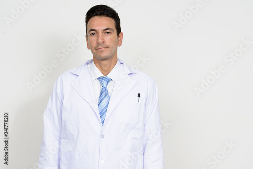 Portrait of mature handsome man doctor looking at camera