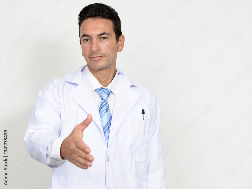 Portrait of mature handsome man doctor giving handshake Portrait of mature handsome man doctor giving handshake
