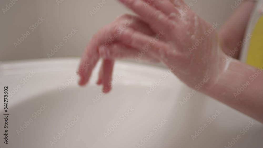 Close up of hands scrubbing thoroughly and making soap bubbles in slow motion Close up of hands scrubbing thoroughly and making soap bubbles in slow motion