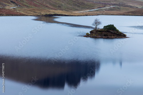 Loch Leathan and Old man of Storr rock formations, Isle of Skye, Scotland. Concept: typical Scottish landscape, tranquility and serenity, particular morphologies. photo