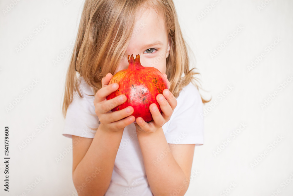 Little girl holding a pomegranate. Symbol of the Jewish New Year. Rosh ha Shana. Little girl holding a pomegranate. Symbol of the Jewish New Year. Rosh ha Shana.
