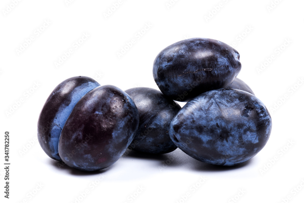 Fresh blue plums, isolated on white background, in close-up. Fresh blue plums, isolated on white background, in close-up.