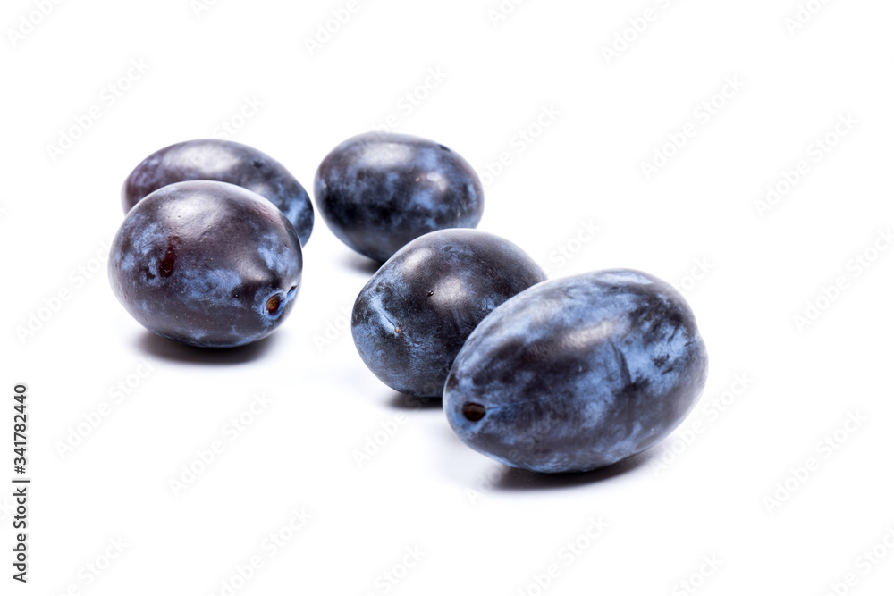 Fresh blue plums, isolated on white background, in close-up. Fresh blue plums, isolated on white background, in close-up.