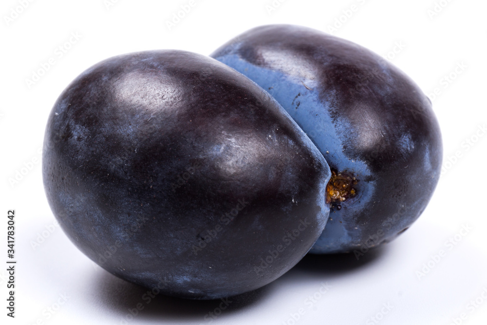 Fresh blue plums, isolated on white background, in close-up. Fresh blue plums, isolated on white background, in close-up.