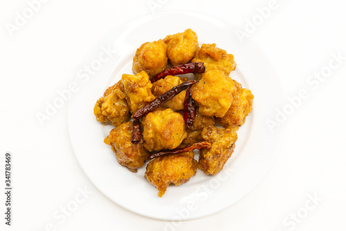 Chinese General Tso's Chicken on white background. General Tso's chicken is a sweet deep-fried chicken dish that is served in North American Chinese restaurants.