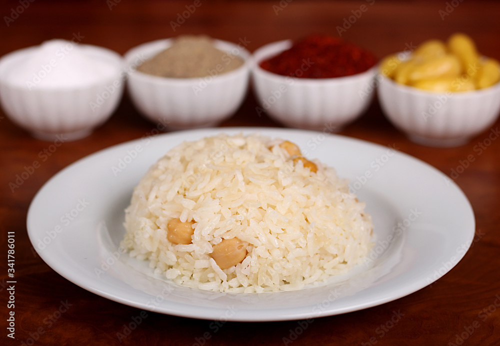 perfect turkish food chickpea rice spicy on white plate on wooden table close up perfect turkish food chickpea rice spicy on white plate on wooden table close up