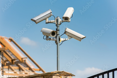 Security cameras, CCTV, video surveillance against blue sky. photo