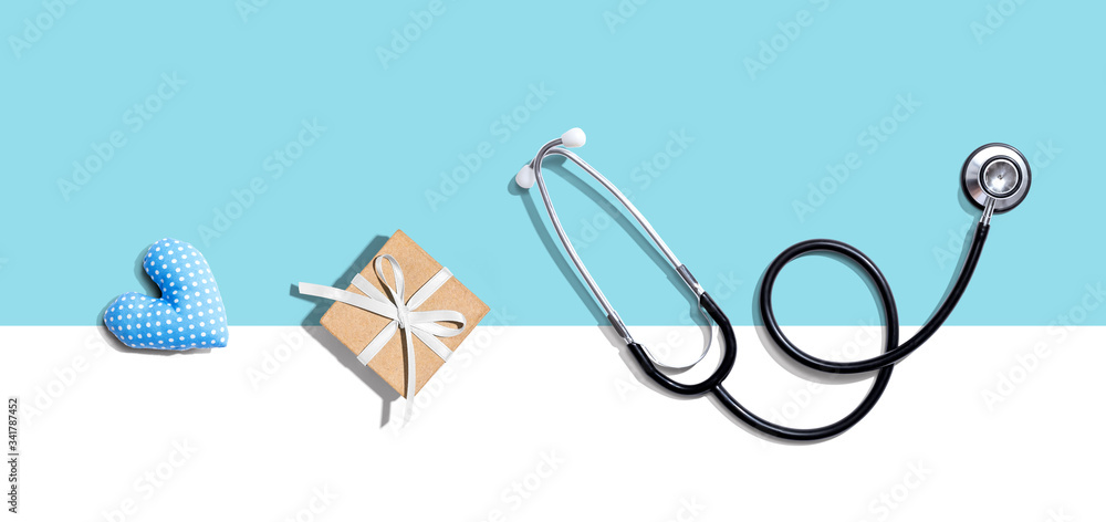 Stethoscope with a gift and a heart cushion - flat lay Stethoscope with a gift and a heart cushion - flat lay
