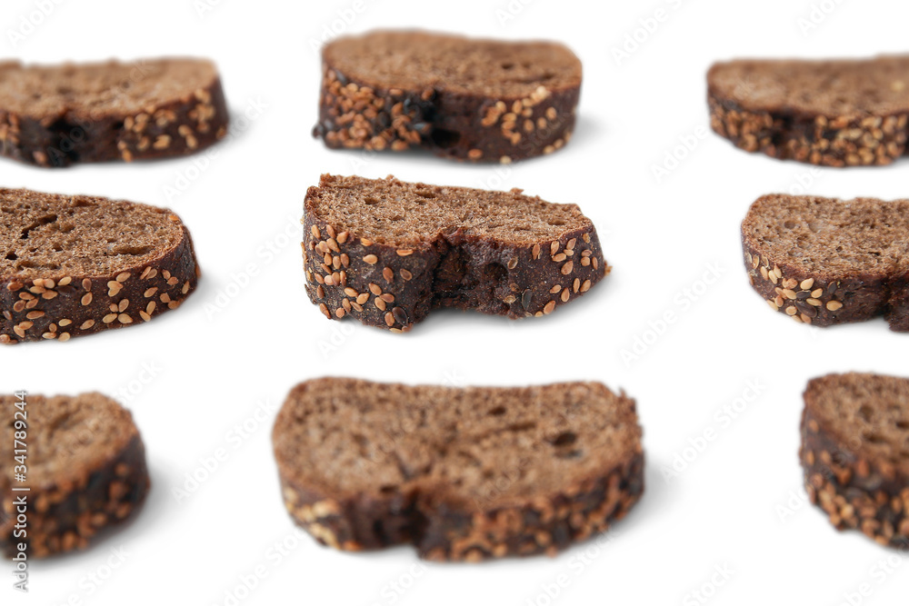 sliced pieces of rye baguette with sesame seeds on a white background sliced pieces of rye baguette with sesame seeds on a white background
