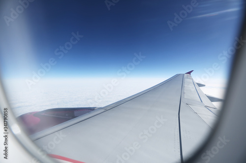 Clouds and sky as seen through window of an aircraft