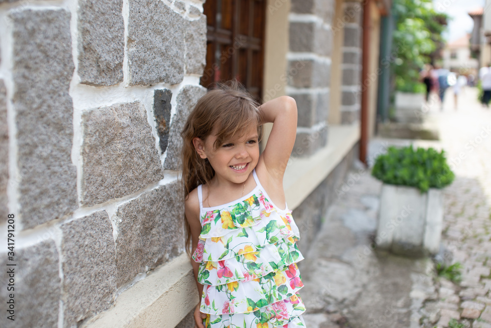 little girl standing near the wall little girl standing near the wall