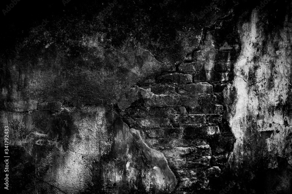 The texture of the crack brick is black. Background of empty cracked brick basement wall. Empty dark black wall.