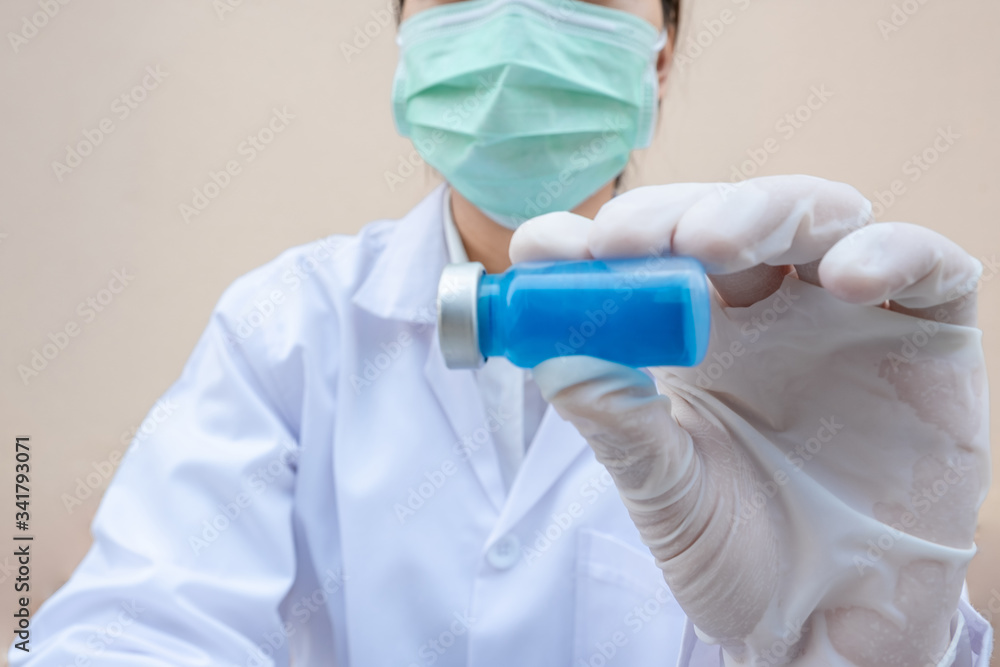 The picture of doctor's hand is holding a blue serum tube The picture of doctor's hand is holding a blue serum tube