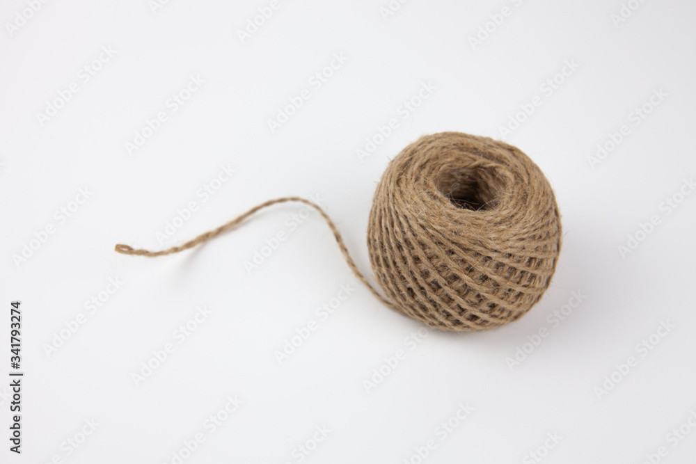 A skein of brown wool for knitting on a white background. Needlework.