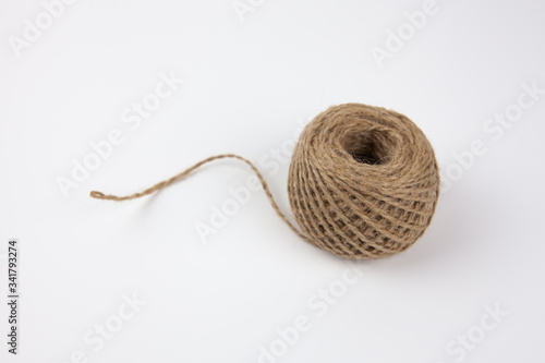 A skein of brown wool for knitting on a white background. Needlework.