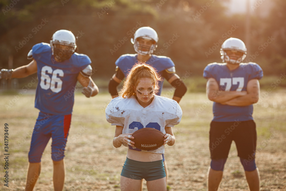 Obraz premium American football woman player in action on the stadium.