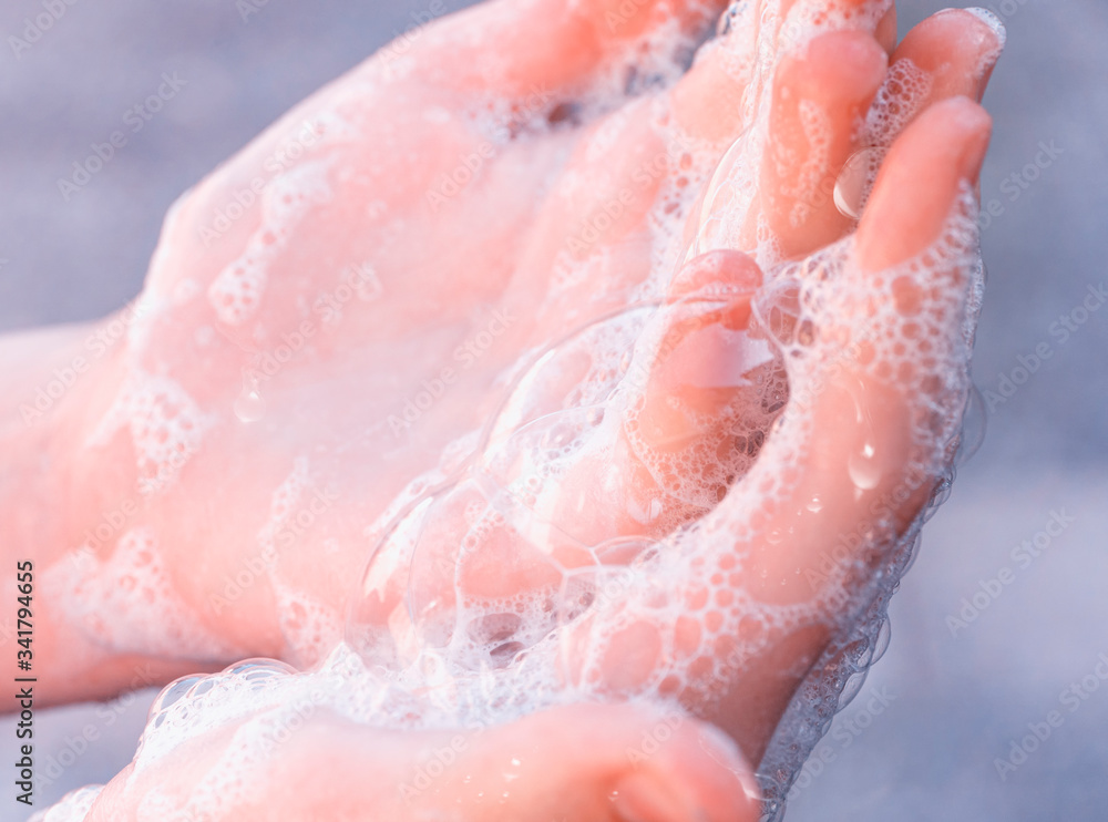 Soap foam on child hands. Covid - 19 Coronavirus prevention. A child wash our hands with antibacterial soap. Coronavirus pandemic protection by frequent hand washing. Selective focus Soap foam on child hands. Covid - 19 Coronavirus prevention. A child wash our hands with antibacterial soap. Coronavirus pandemic protection by frequent hand washing. Selective focus