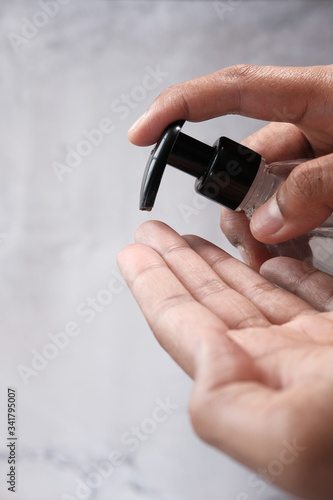 Man using hand sanitizer for preventing virus 