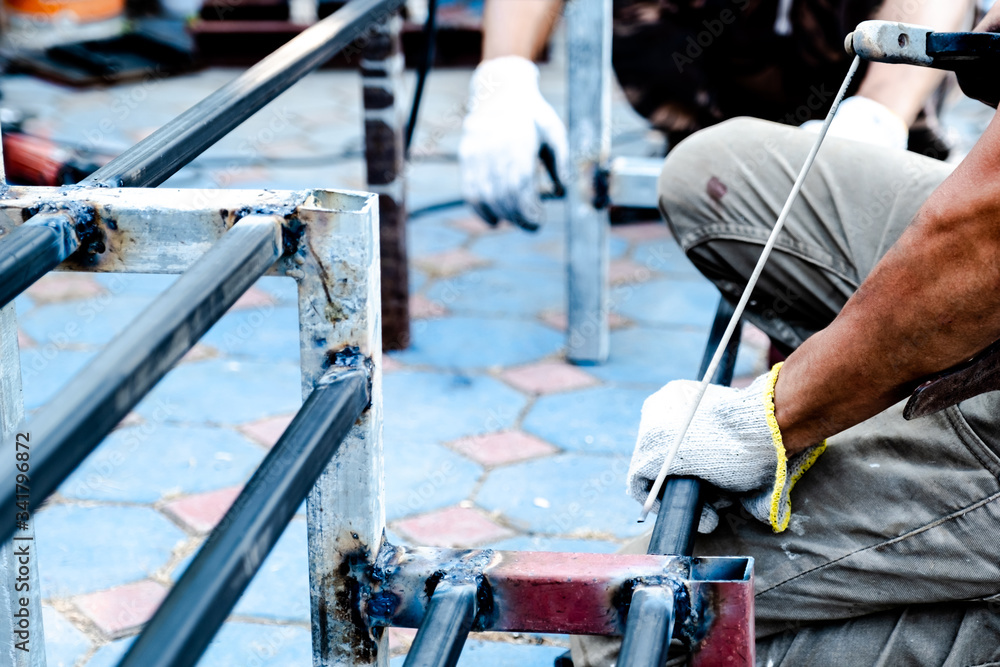 The mechanic is using a welding machine to weld steel The mechanic is using a welding machine to weld steel