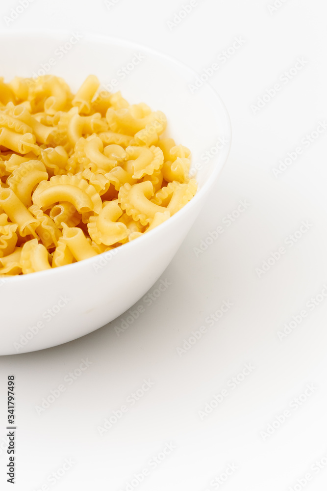 Delicious pasta or penne noodles, isolated on white background. Top view scene, healthy eating or healthy lifestyle. Penne pasta or macaroni in a white bowl, italian cuisine. Delicious pasta or penne noodles, isolated on white background. Top view scene, healthy eating or healthy lifestyle. Penne pasta or macaroni in a white bowl, italian cuisine.